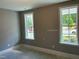 Sunlit bedroom with natural light streaming through two white-framed windows at 9169 Dupree Meadow Dr # 26, Angier, NC 27501