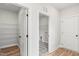 Walk-in closets feature custom shelving, white doors and dark, decorative flooring in a modern, airy space at 9169 Dupree Meadow Dr # 26, Angier, NC 27501