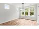Bright dining room with light wood floors, white trim, and large windows with a view of the outdoors at 9169 Dupree Meadow Dr # 26, Angier, NC 27501