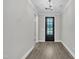 Entryway featuring dark-stained wood door and trim, neutral paint, and wood floors at 9169 Dupree Meadow Dr # 26, Angier, NC 27501