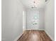Inviting home foyer with hardwood floors, white trim, a decorative light fixture, and a glass-paneled front door at 9169 Dupree Meadow Dr # 26, Angier, NC 27501
