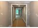 Hallway leading to a room with natural light and a fireplace at 9169 Dupree Meadow Dr # 26, Angier, NC 27501