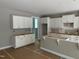 Unfinished kitchen featuring shaker style cabinets and an island ready for countertops at 9169 Dupree Meadow Dr # 26, Angier, NC 27501