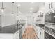Modern kitchen featuring white cabinets, black hardware, granite countertops and stainless steel appliances at 9169 Dupree Meadow Dr # 26, Angier, NC 27501