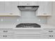 Close up of the cooktop, cabinetry and light gray tile backsplash in this updated kitchen at 9169 Dupree Meadow Dr # 26, Angier, NC 27501