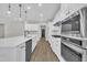 A modern kitchen features stainless appliances, white cabinets, and a large kitchen island at 9169 Dupree Meadow Dr # 26, Angier, NC 27501