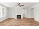 Bright living room with a fireplace, ceiling fan, and wood-look flooring, perfect for relaxation and gatherings at 9169 Dupree Meadow Dr # 26, Angier, NC 27501