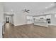 Bright living room showcasing an open floor plan, modern kitchen with an island, and hardwood floors at 9169 Dupree Meadow Dr # 26, Angier, NC 27501
