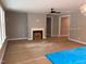 Spacious living room features a classic fireplace and ceiling fan, bathed in natural light at 9169 Dupree Meadow Dr # 26, Angier, NC 27501