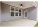 Covered patio with concrete floor, ceiling fan, and windows offering natural light at 9169 Dupree Meadow Dr # 26, Angier, NC 27501