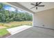 Covered outdoor patio with ceiling fan, overlooking a serene pond and wooded area at 9169 Dupree Meadow Dr # 26, Angier, NC 27501