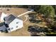 Aerial view of the property showcasing a spacious, fenced backyard with a fire pit and wooded area at 99 Bodacious Ln, Benson, NC 27504