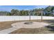 Landscaped backyard featuring a fire pit surrounded by white gravel, perfect for outdoor entertaining at 99 Bodacious Ln, Benson, NC 27504