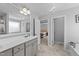 Bright bathroom showcasing a double vanity, tiled floors, decorative lighting, and access to main bedroom at 99 Bodacious Ln, Benson, NC 27504