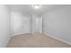 Spare bedroom showcasing carpet floors, a large closet, neutral paint and doorway at 99 Bodacious Ln, Benson, NC 27504