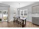 Bright dining area with hardwood floors, a modern chandelier, and natural light at 99 Bodacious Ln, Benson, NC 27504