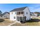 Rear exterior of a two-story white house with a screened porch and balcony at 99 Bodacious Ln, Benson, NC 27504