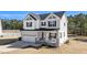 Charming two-story home with gray and white siding, covered porch, and attached two-car garage at 99 Bodacious Ln, Benson, NC 27504