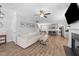 Open concept living room with a fireplace, ceiling fan, hardwood floors, and neutral colors at 99 Bodacious Ln, Benson, NC 27504