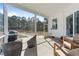 Inviting screened porch with comfortable seating and a view of the serene backyard at 99 Bodacious Ln, Benson, NC 27504