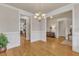 Open dining room featuring hardwood floors, wainscoting, and chandelier lighting at 1009 River Commons Dr, Knightdale, NC 27545