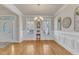 Well-lit dining room showcasing wainscoting, a chandelier, and hardwood floors, ideal for formal dinners and Gathering meals at 1009 River Commons Dr, Knightdale, NC 27545