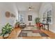 Bright living room with high ceilings, plants, ceiling fan, and large windows at 1009 River Commons Dr, Knightdale, NC 27545