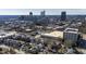 An aerial view of a vibrant cityscape, blending residential houses with towering buildings against a bright blue sky backdrop at 101 S Bloodworth St, Raleigh, NC 27601