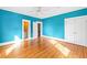 Bedroom with blue walls, hardwood floors, ceiling fan, closet and bathroom access at 101 S Bloodworth St, Raleigh, NC 27601