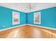 Bedroom with blue walls, hardwood floors, ceiling fan and two windows at 101 S Bloodworth St, Raleigh, NC 27601