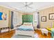 Tranquil bedroom features hardwood floors, a ceiling fan, and soothing decor at 101 S Bloodworth St, Raleigh, NC 27601