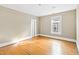 Empty bedroom with hardwood floors, neutral walls and a bright window provides natural light at 101 S Bloodworth St, Raleigh, NC 27601