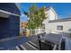 Well-designed deck with a dining table set, striped rug, and comfortable seating amidst lush greenery at 101 S Bloodworth St, Raleigh, NC 27601
