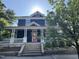 Charming two-story home featuring a vibrant pink front door, inviting porch, and well-maintained landscaping at 101 S Bloodworth St, Raleigh, NC 27601