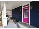Charming front porch with a seating area and a vibrant pink door, creating a welcoming entrance at 101 S Bloodworth St, Raleigh, NC 27601