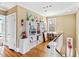 Hallway with hardwood floors, white shelving with decor, fire extinguishers, and natural light at 101 S Bloodworth St, Raleigh, NC 27601