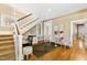 Bright living room featuring hardwood floors, a staircase, and decorative seating for elegant and comfortable living at 101 S Bloodworth St, Raleigh, NC 27601