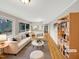 Bright and airy living room featuring a sofa, armchair, modern decor, and an open concept design at 106 Woodland Dr, Cary, NC 27513