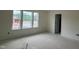 Bedroom with large windows offers natural light and neighborhood views, and an open doorway at 107 Willow Cameron Way, Angier, NC 27501
