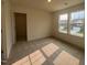 Well-lit bedroom features plush carpeting and a large window with a neighborhood view at 107 Willow Cameron Way, Angier, NC 27501