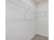 White closet with metal rack and beige carpet at 107 Willow Cameron Way, Angier, NC 27501