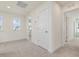 Hallway featuring carpet, white doors, and an exterior window at 107 Willow Cameron Way, Angier, NC 27501