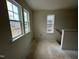 Hallway with natural light and staircase that leads to the top floor rooms at 107 Willow Cameron Way, Angier, NC 27501