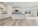 Modern kitchen with white cabinets, granite countertops, and stainless steel appliances at 107 Willow Cameron Way, Angier, NC 27501