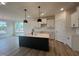 Spacious kitchen featuring a center island, white cabinets and modern pendant lighting at 107 Willow Cameron Way, Angier, NC 27501