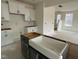 Close-up of kitchen island with a white undermount sink and white cabinets at 107 Willow Cameron Way, Angier, NC 27501