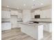 Well-lit kitchen with white cabinetry, granite countertops, and a center island at 107 Willow Cameron Way, Angier, NC 27501