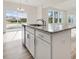 Kitchen island with granite countertop, stainless steel sink, and views of the backyard pond at 107 Willow Cameron Way, Angier, NC 27501