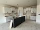 An unfinished kitchen with white cabinets and a dark island at 107 Willow Cameron Way, Angier, NC 27501