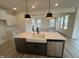 Stylish kitchen island featuring a farmhouse sink and modern stainless steel dishwasher at 107 Willow Cameron Way, Angier, NC 27501